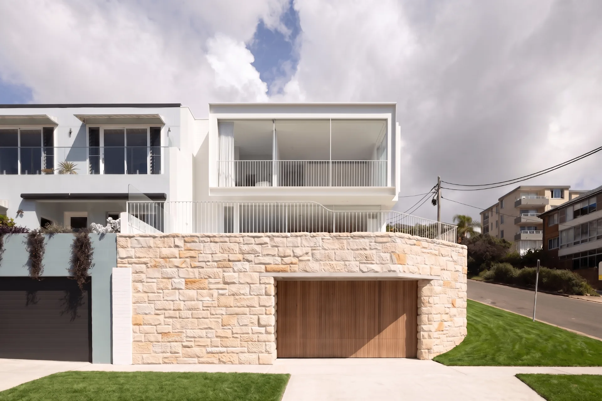 Contemporary beachside home with timber garage and stone base