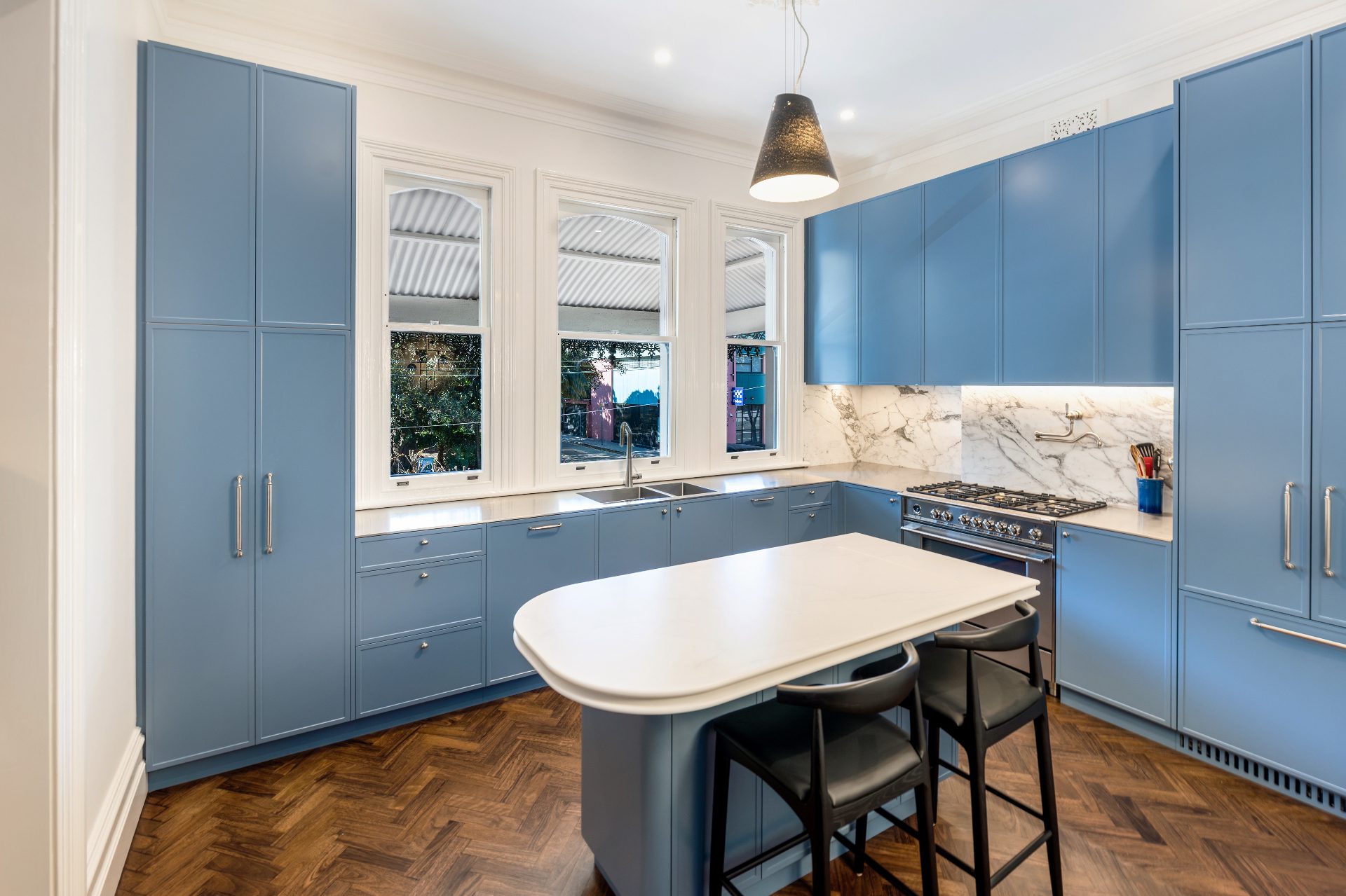 Heritage kitchen renovation with blue cabinetry and marble splashback